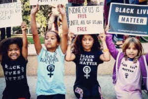 Children holding Black Lives Matter signs